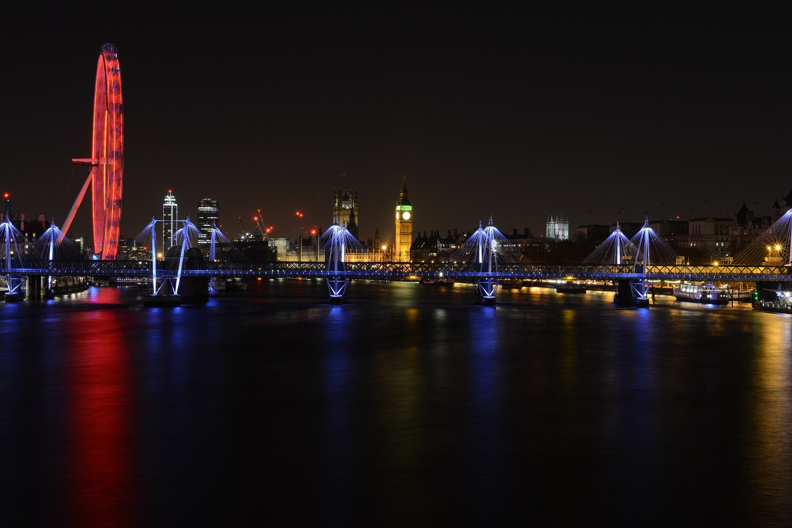 The London Eye and Big Ben at night over the Thames